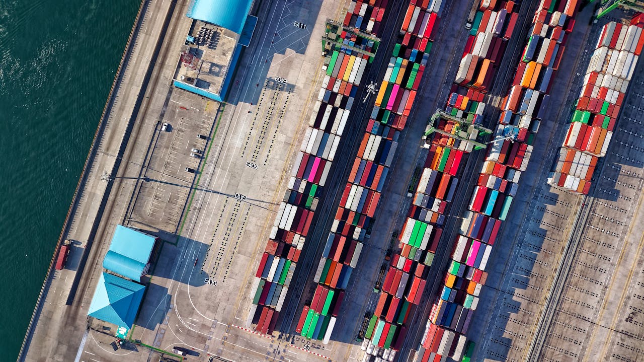 services-06 Top view of colorful shipping containers at a bustling port in Jakarta, Indonesia.