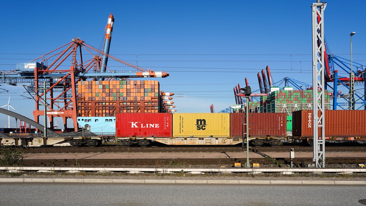 services-01 Colorful shipping containers and cranes at Hamburg port symbolize global trade and logistics.
