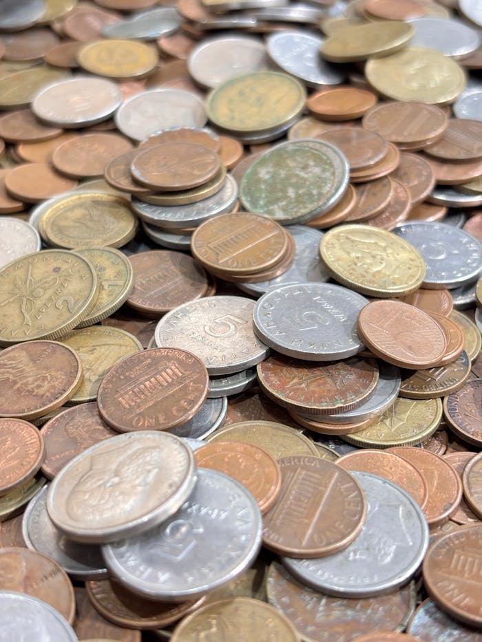 services-05 A detailed view of various international currency coins in a pile.