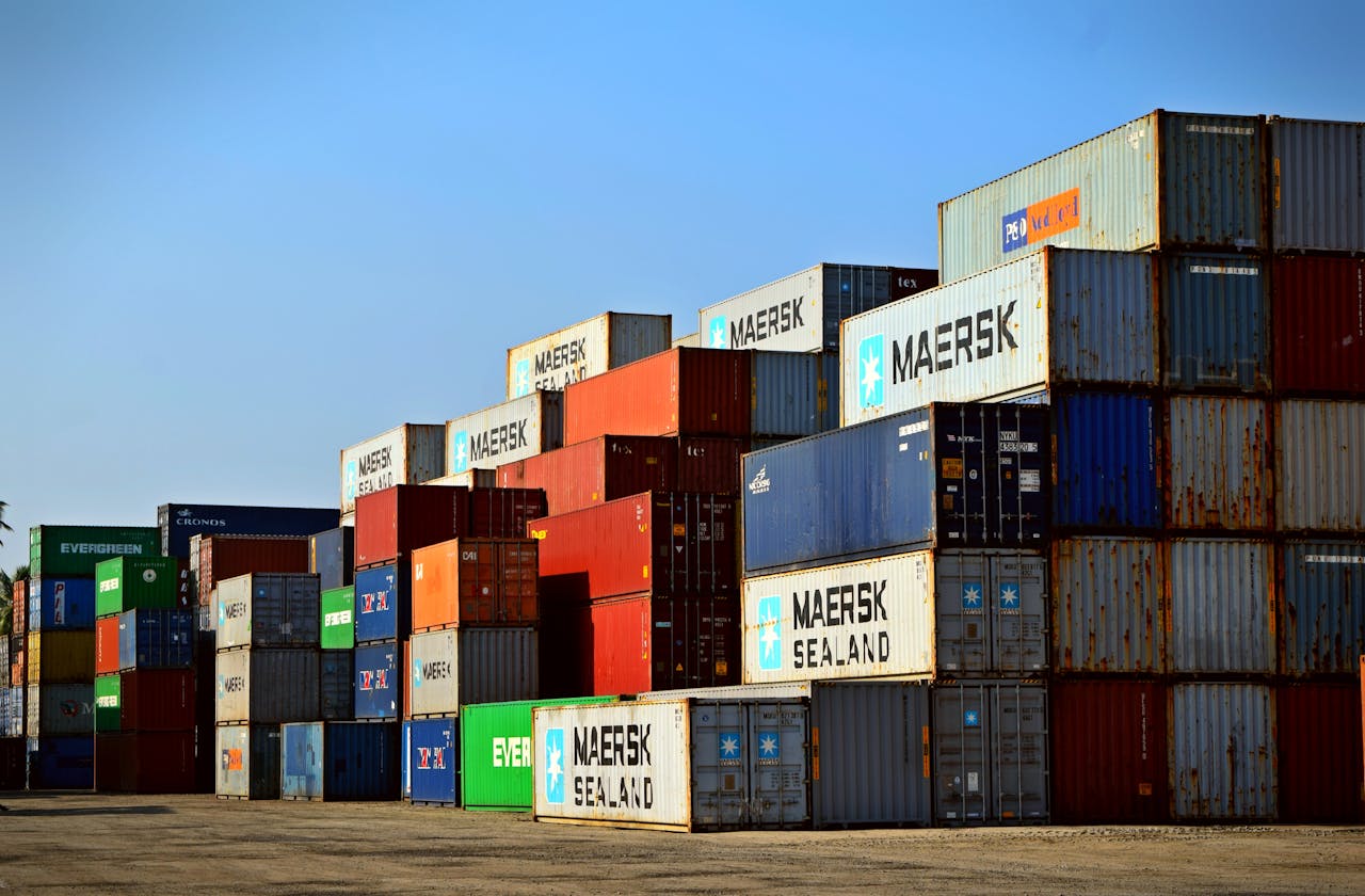 services-bg Colorful stacked shipping containers at a port exemplify global logistics.
